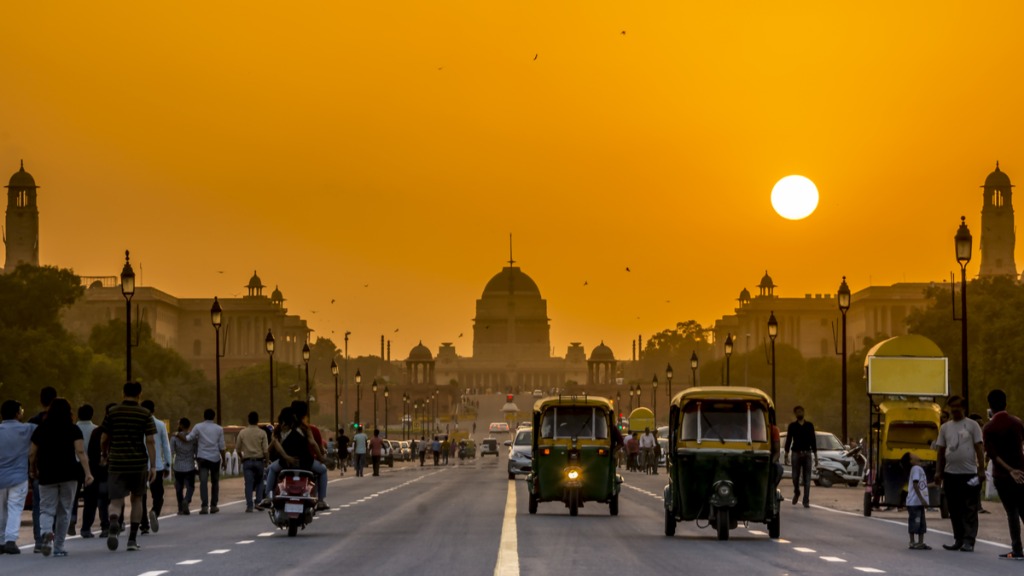 Golden sunrise over grand Indian architectural domes and boulevards